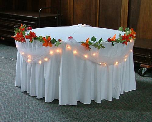 Table with flower garland and lights