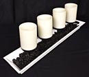 candle centrepiece with river rocks