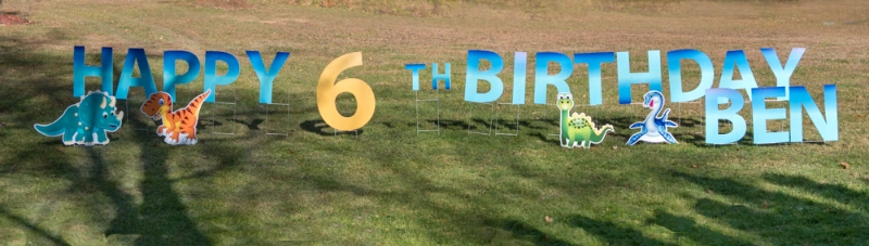 Happy Birthday sign on lawn with letters and graphics