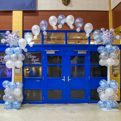 blue and white snowflake balloon arch