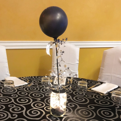 single black balloon and gold decor centrepiece