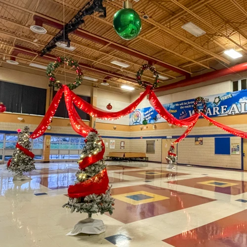 Christmas tree columns and red swags with mini lights