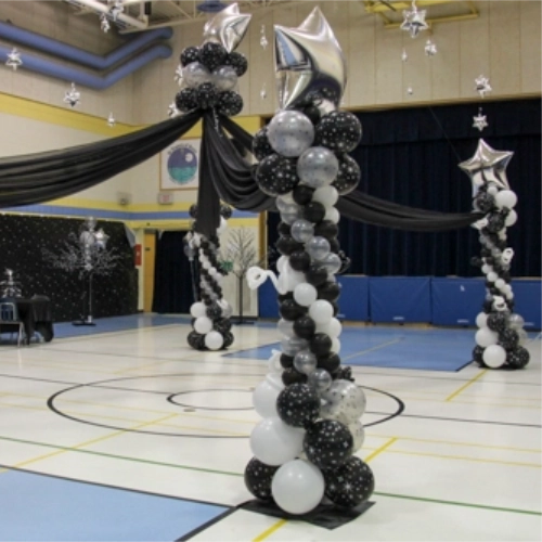 black, white, and silver columns with silver star tops and black draping