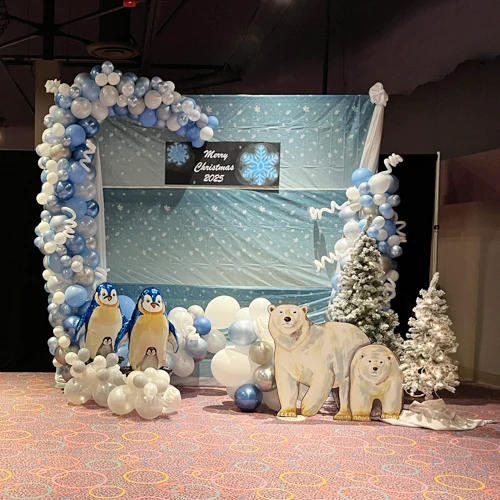 blue and white organic balloon arch with winter scene for Christmas party