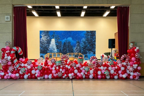 red and white candy balloon border for stage at a Christmas party