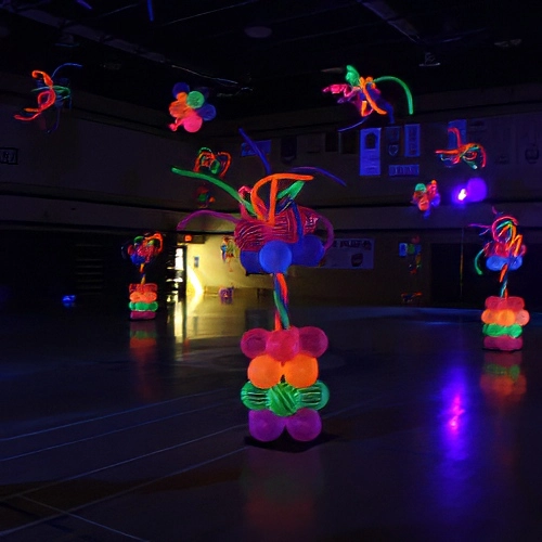 high school dance with glow-in-the-dark balloon columns