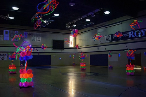 high school dance with glow-in-the-dark balloon columns