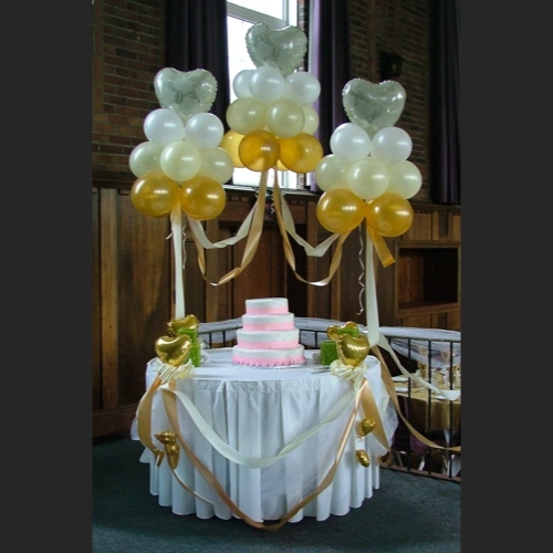 cake table with gold accents and balloon clouds