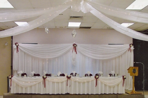 head table with draping and backdrop,  and burgundy accents