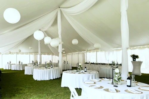 white organza decor, ceiling treatment, and tables