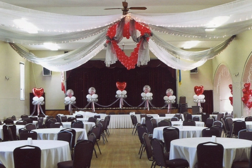 white ceiling swags with mini lights and red balloon heart in centre