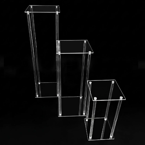 clear acrylic plinths can be used to display wedding cakes, floral arrangements, and signage