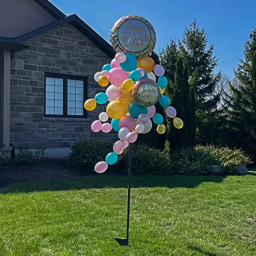 pink, turquoise, and gold balloon bouquet on a pole