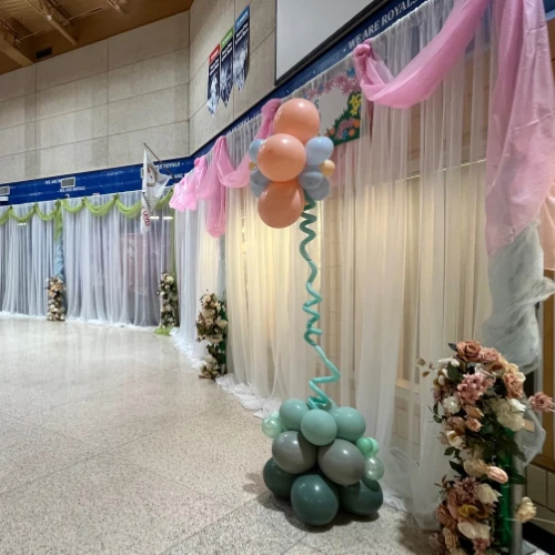 spring dance decor with balloon flowers and pink and green organza swags