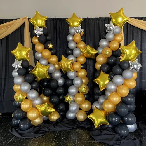 High school prom Starry Nights sculpture in gold, white, and black balloons with gold foil stars