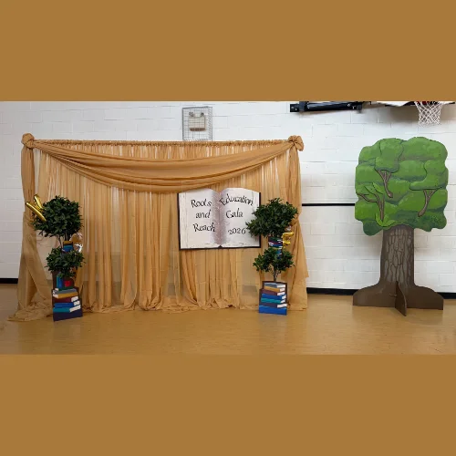 backdrop and wooden tree for Education Gala, with books and trees